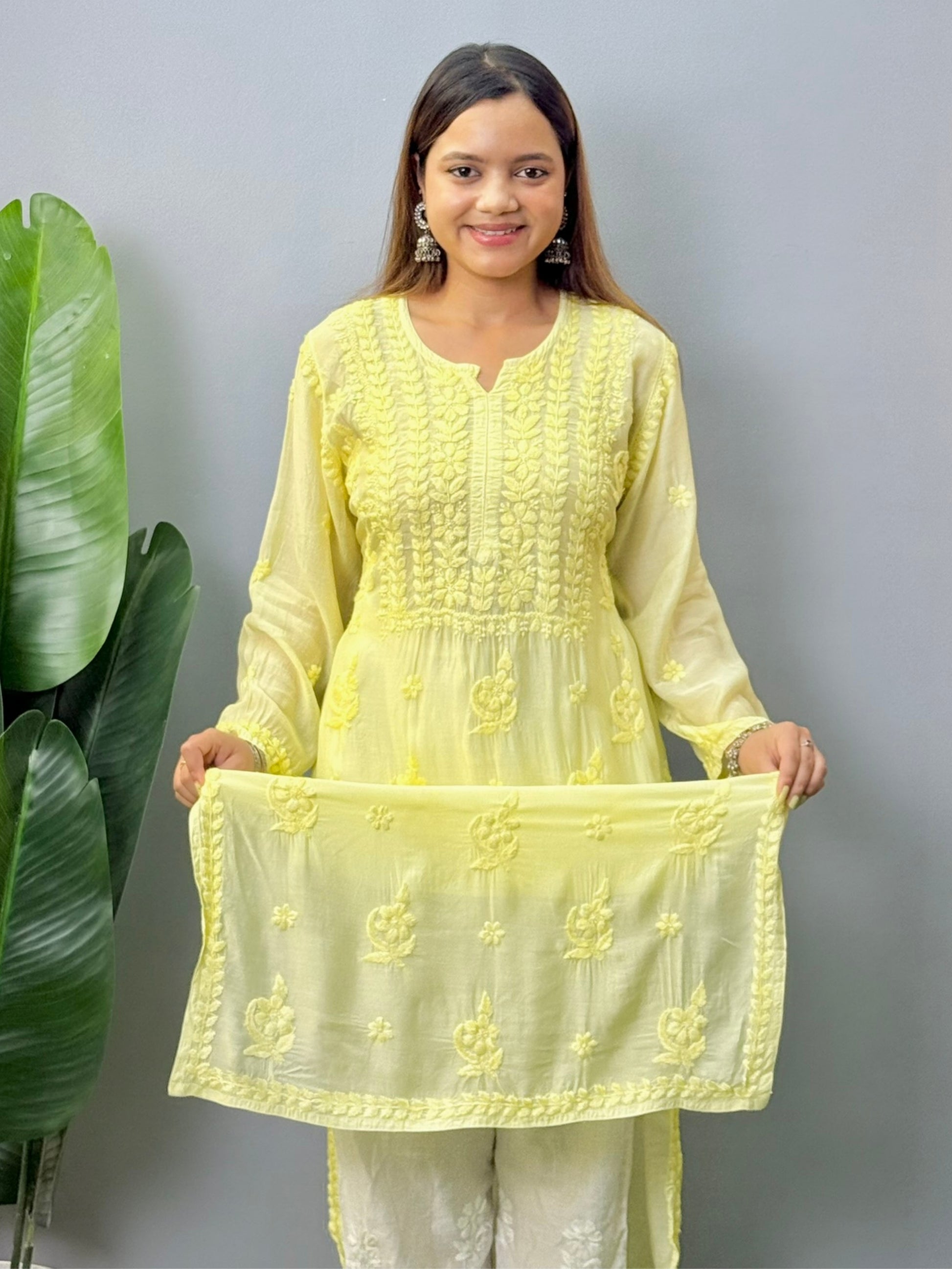 Model wearing lemon yellow muslin chikankari kurta with white pants