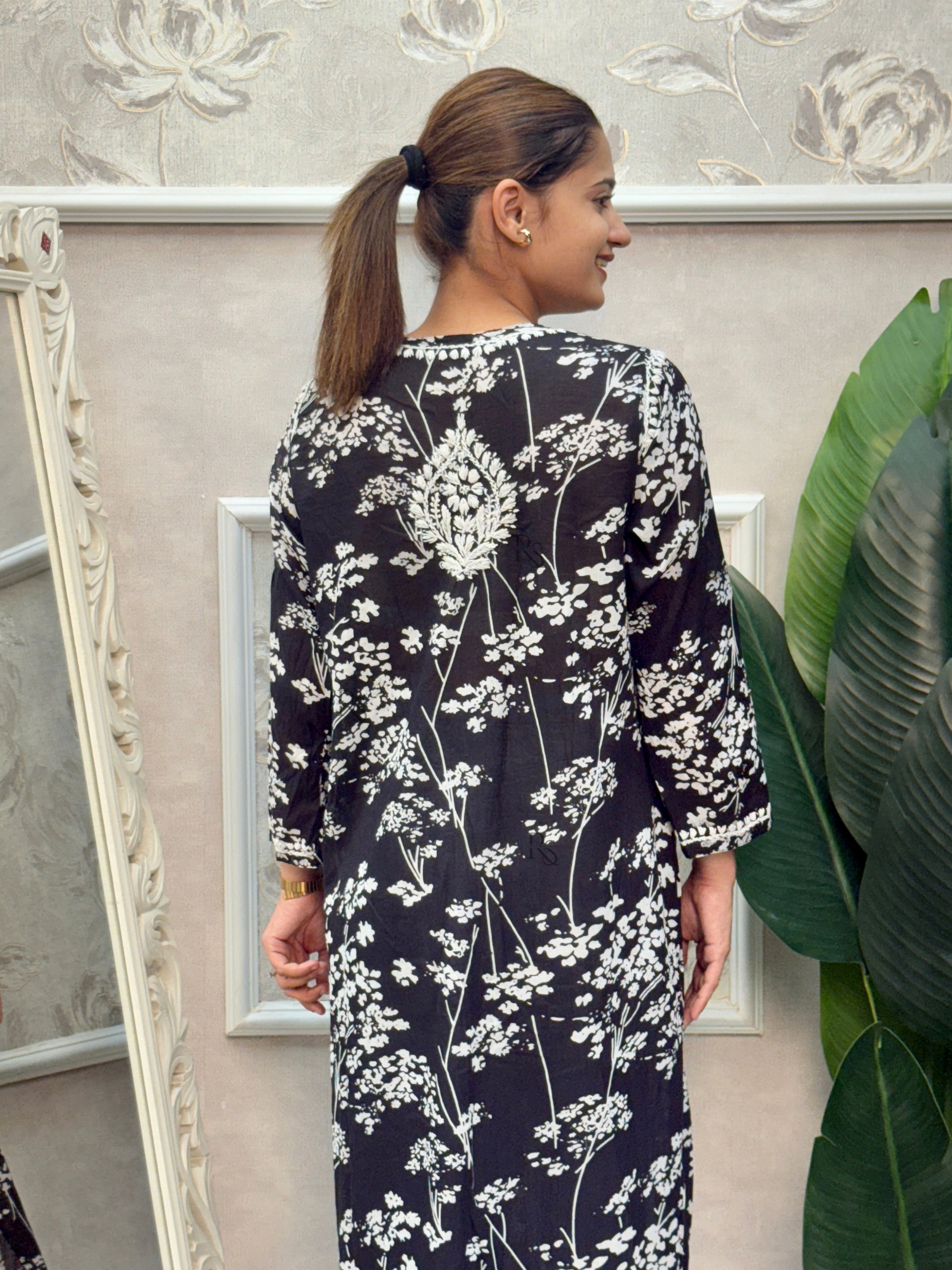 Black printed mulmul Lucknow Chikankari kurta with white floral embroidery.