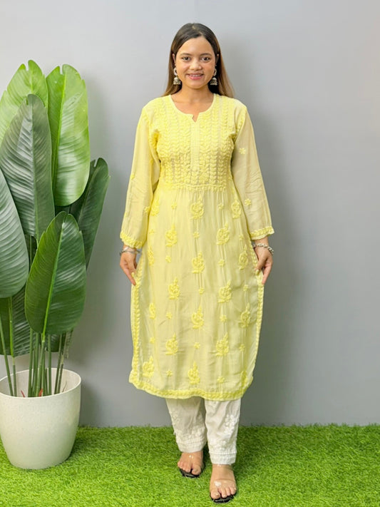 Model wearing lemon yellow muslin chikankari kurta with white pants