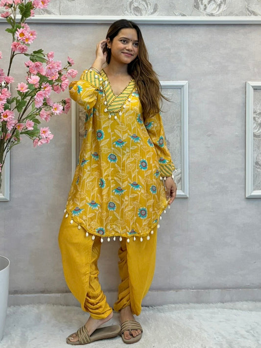 Yellow floral muslin kurta with dhoti pant set featuring shell work and printed design