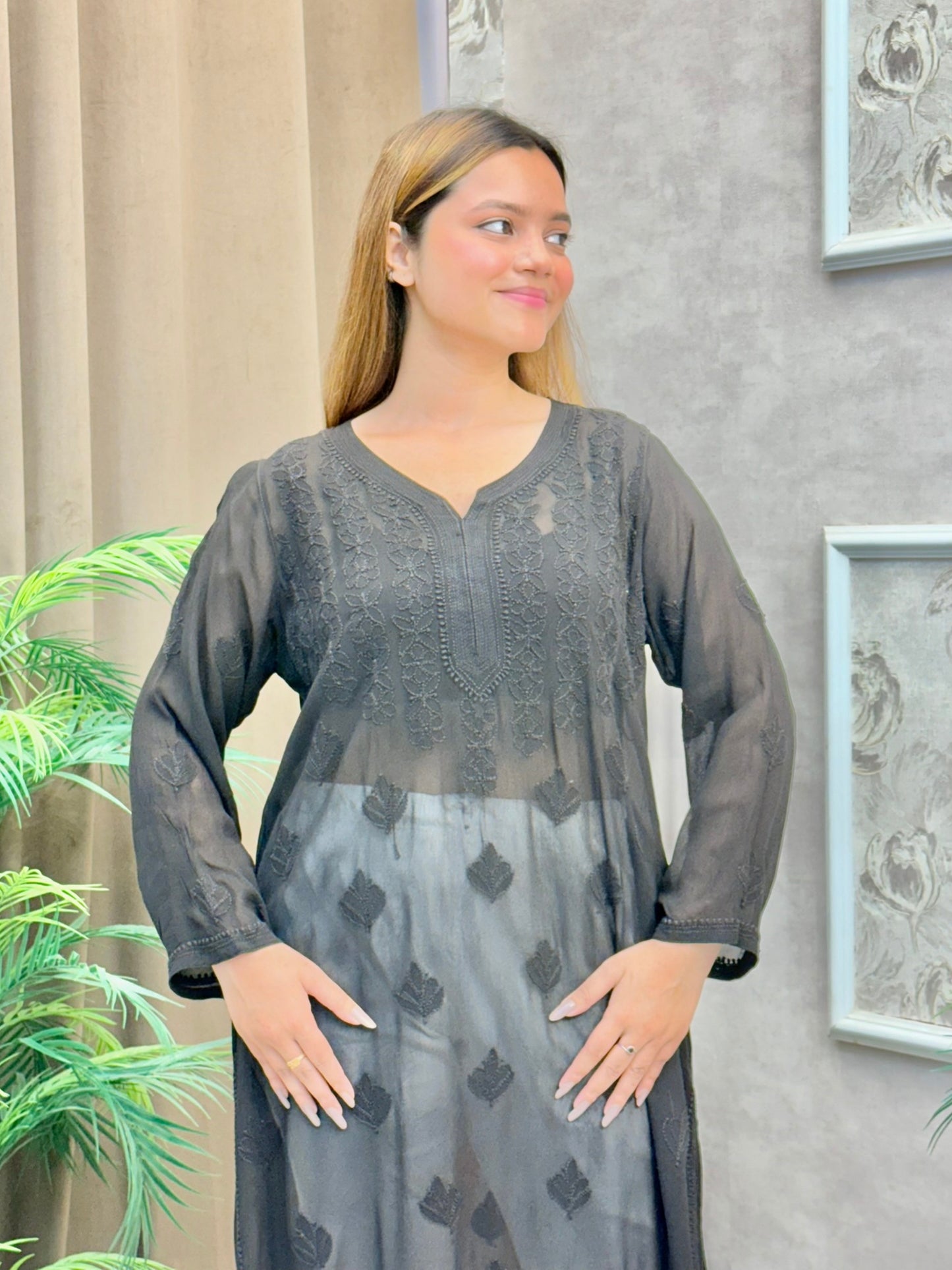 Woman wearing charcoal black chikankari kurta with tonal embroidery and V-neck design