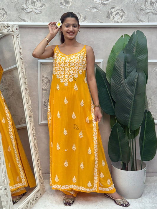 Mustard yellow sleeveless Lucknow Chikankari rayon kurta and pant set with white hand embroidery.