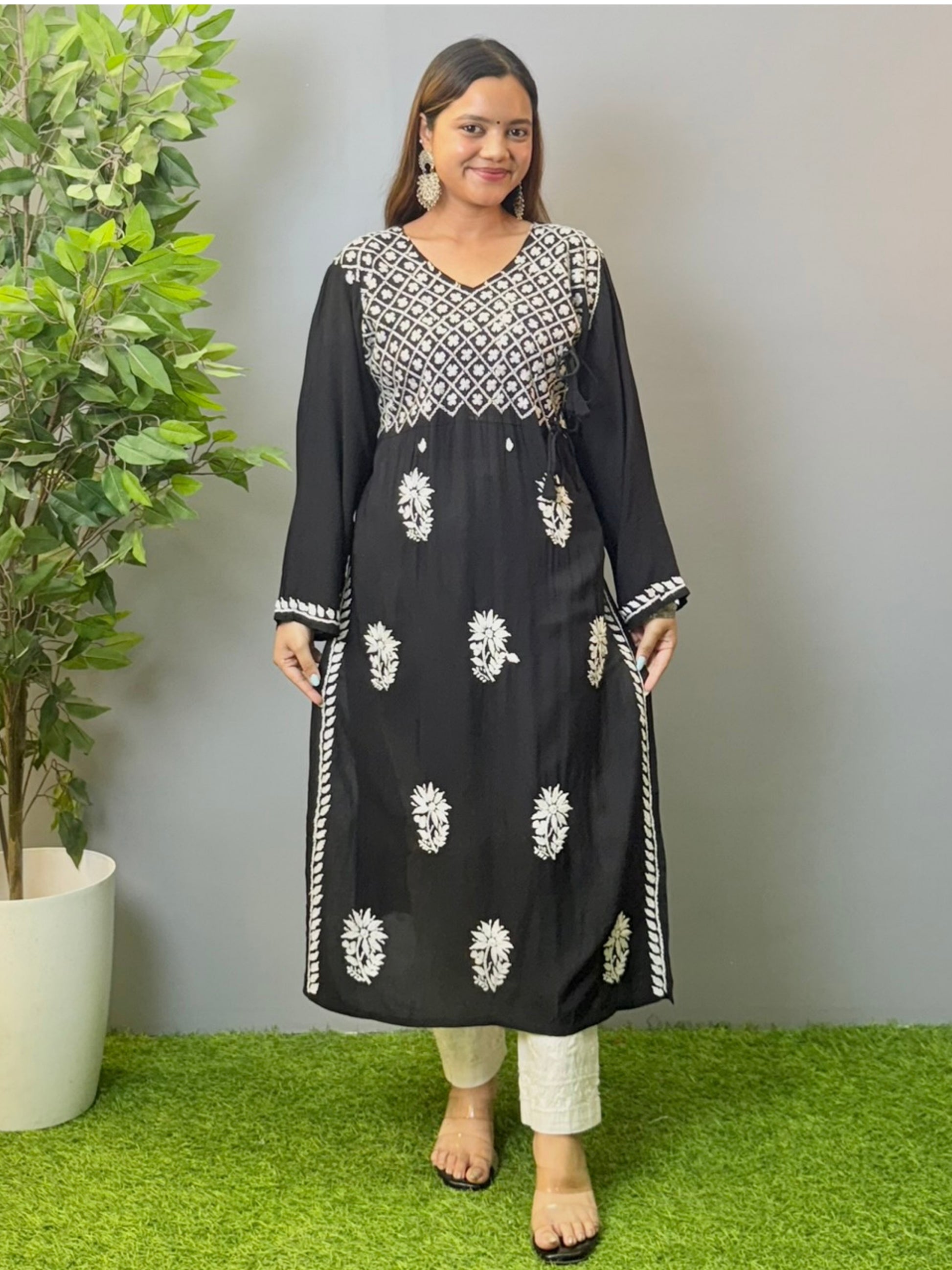 Model wearing a black modal angrakha kurta with elegant white chikankari embroidery and straight silhouette.