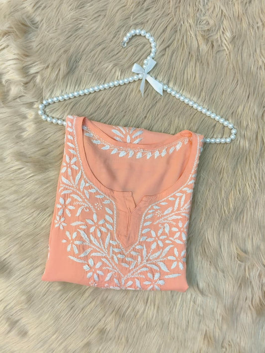Peach modal short kurta with white hand-embroidered Lucknowi Chikankari design.
