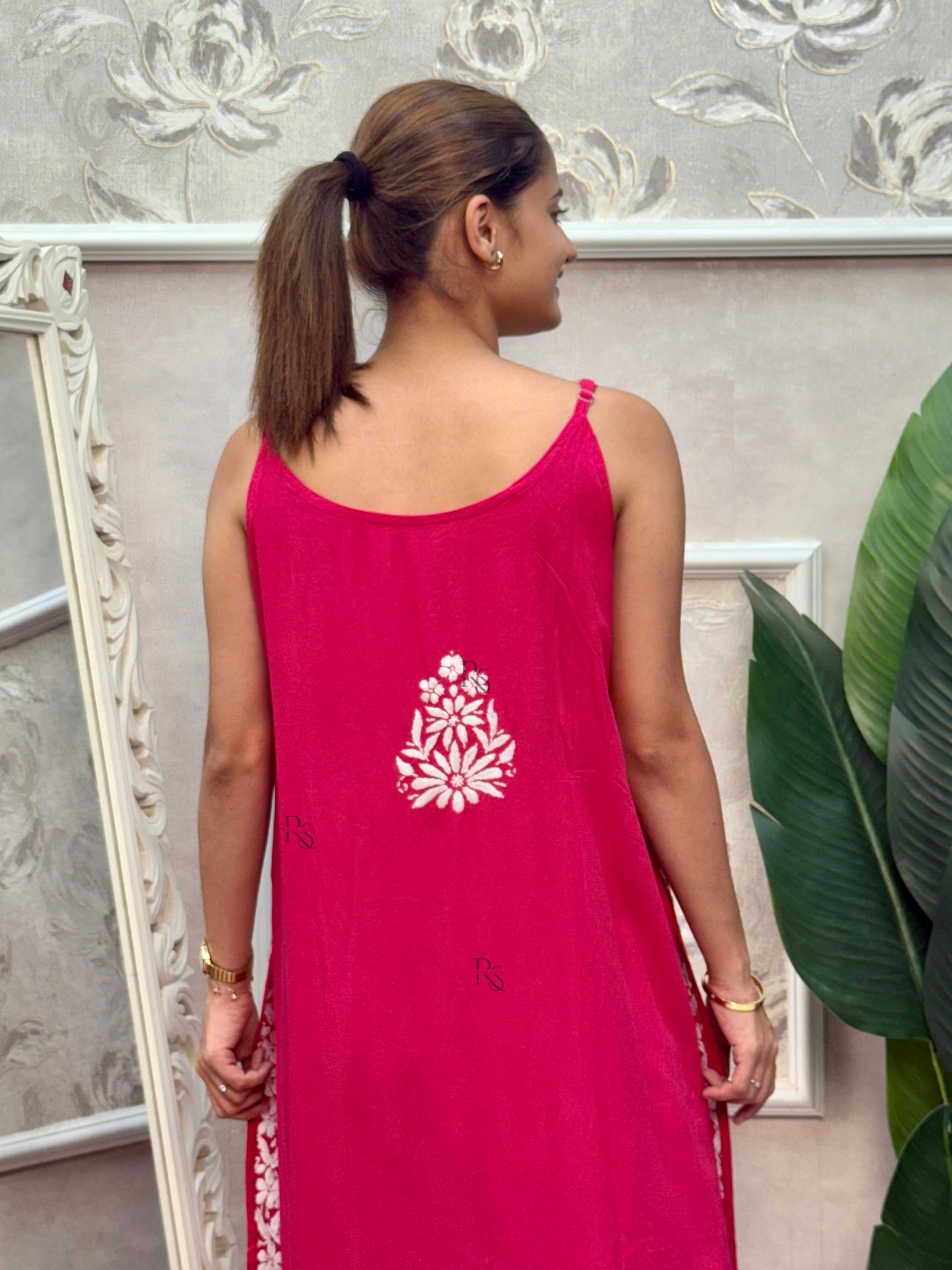 Rani pink sleeveless Lucknow Chikankari rayon kurta and pant set with white hand embroidery.