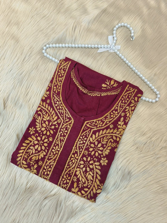 Maroon cotton short chikankari kurta with mustard hand embroidery laid flat on fur background
