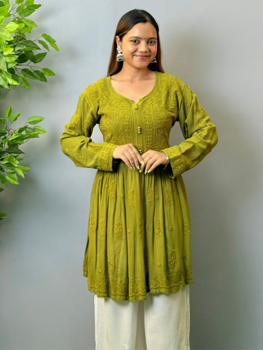 Woman wearing mustard green angrakha-style short chikankari kurta in viscose fabric with flared silhouette