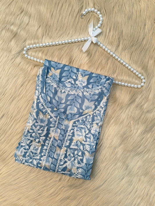 Flat lay of powder blue printed mulmul chikankari kurta with hand embroidery