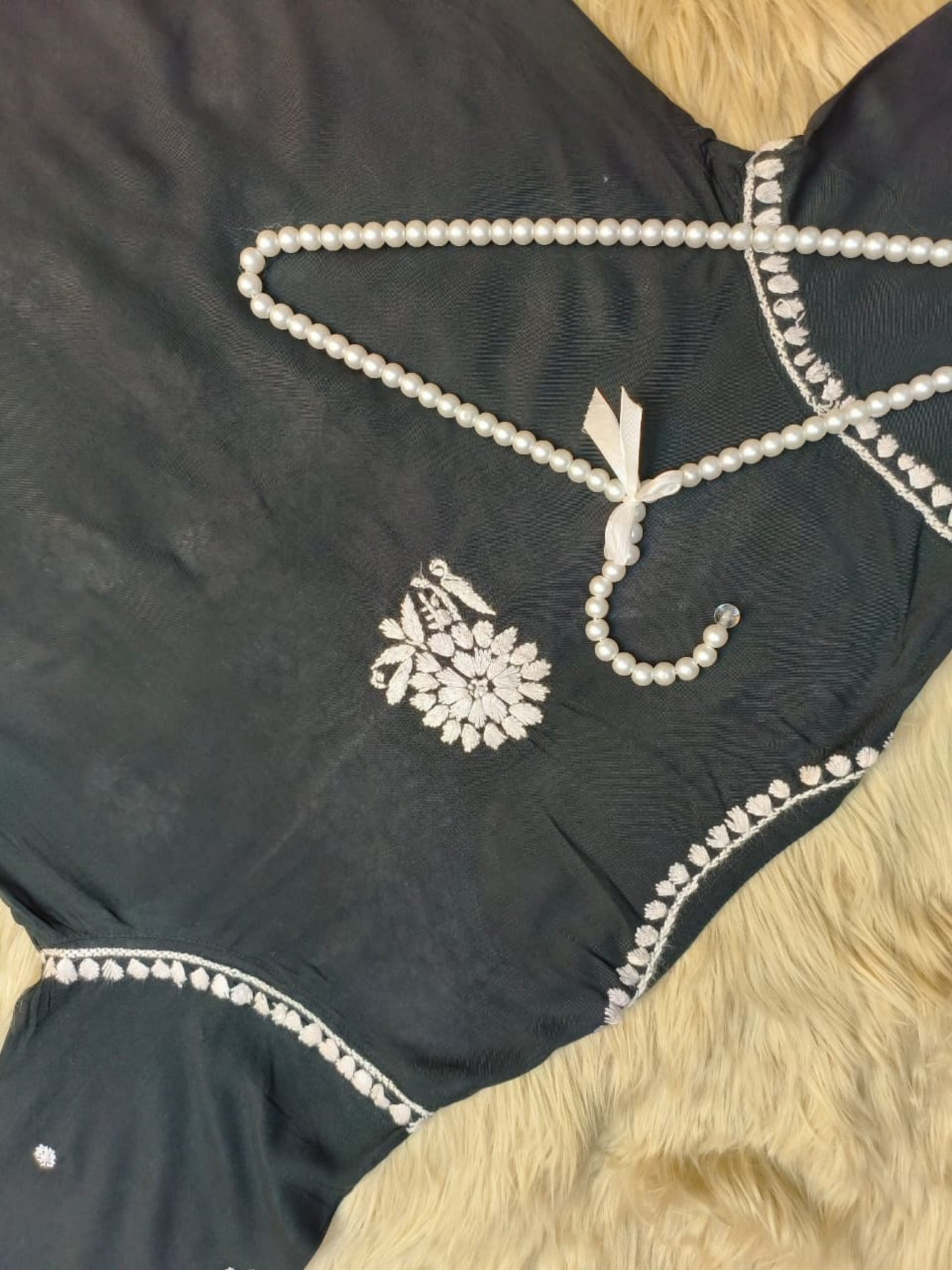 Black rayon Lucknow Chikankari kurta and palazzo set with intricate white hand embroidery.