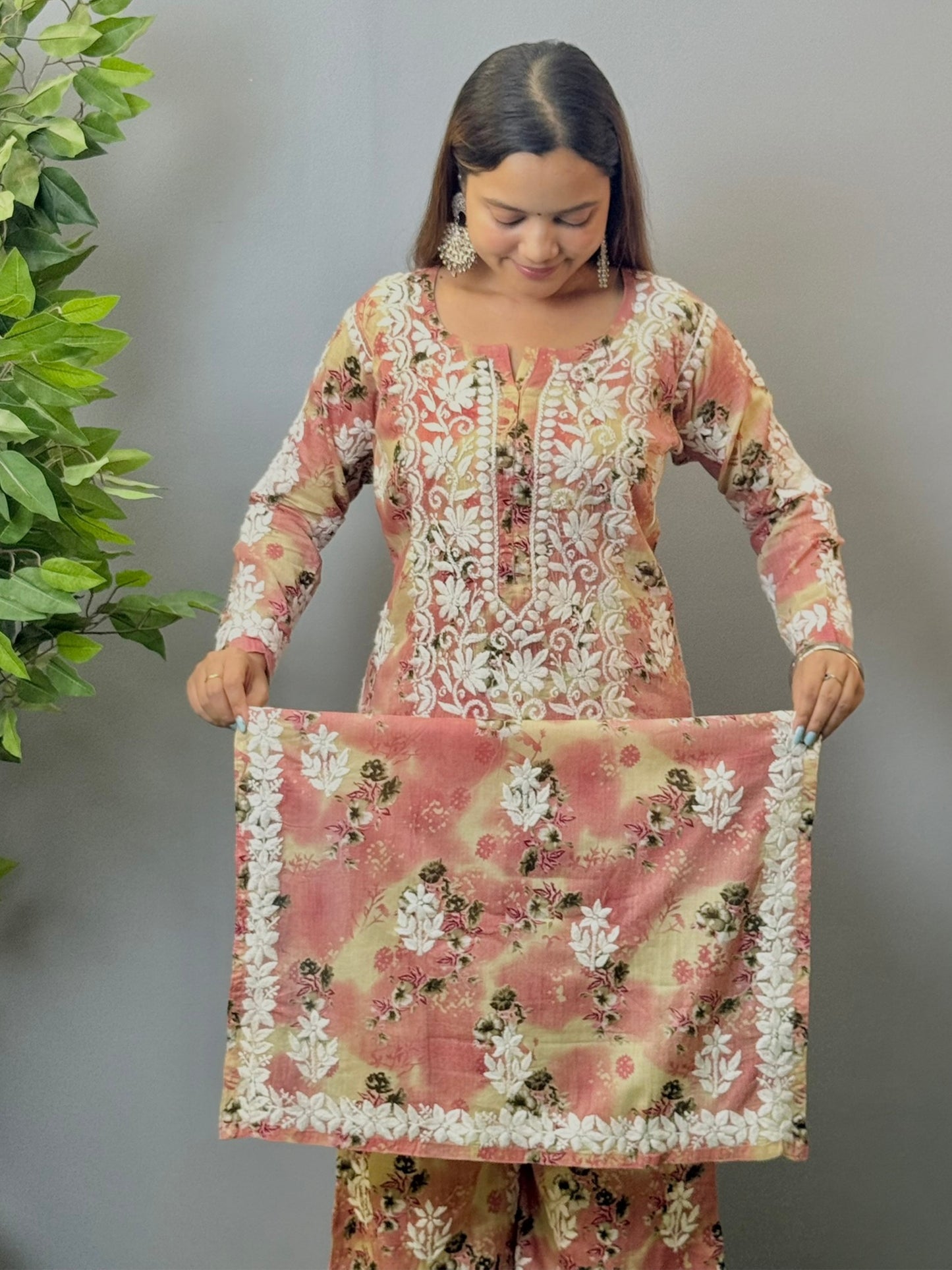 Model wearing a blush peach floral printed chikankari kurta and palazzo set in soft mulmul fabric.