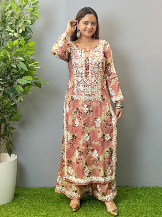 Model wearing a blush peach floral printed chikankari kurta and palazzo set in soft mulmul fabric.