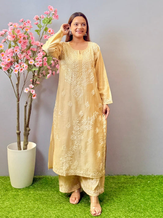 Woman wearing beige golden Chikankari kurta and palazzo set with elegant hand embroidery in chanderi fabric