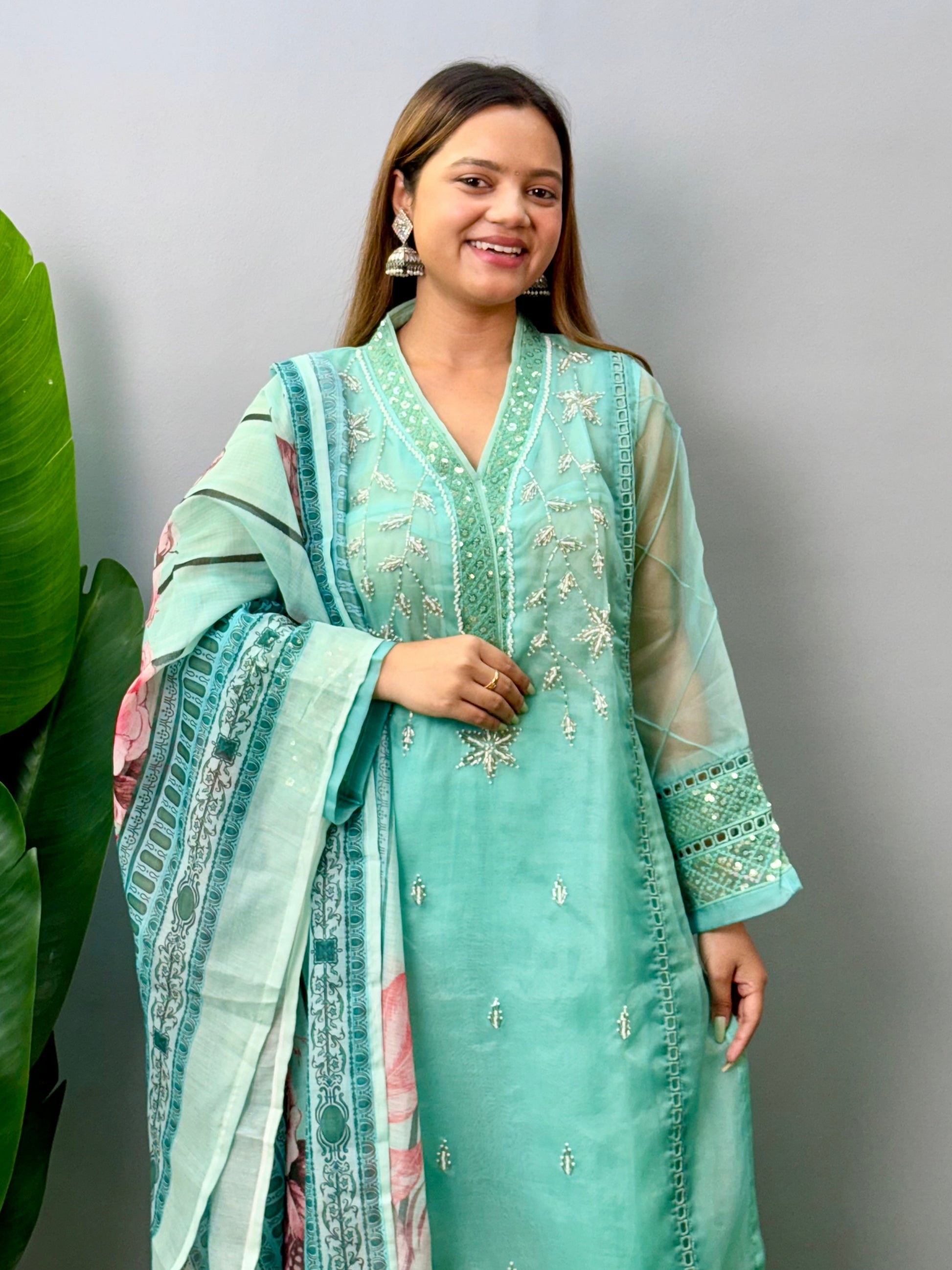 Model wearing a mint green organza kurta with rayon pants and printed cotton dupatta – Designer Wear Collection.