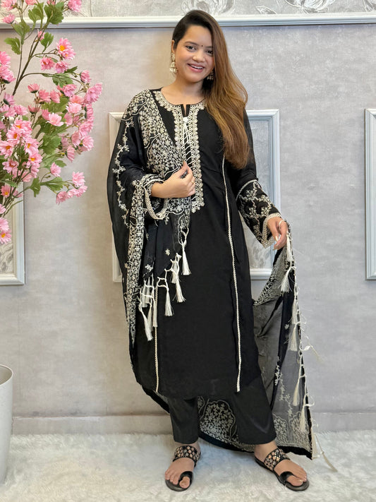 Model wearing a black georgette kurta with lycra stretchable pants and embroidered georgette dupatta with tassels – Designer Wear Collection.