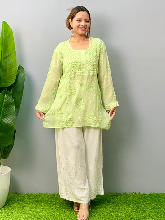 Woman in pista green short Lucknowi chikankari kurta with 3D embroidery on translucent viscose fabric