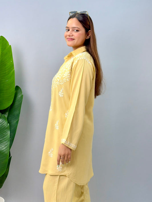 Woman in lemon yellow chikankari coord set with collared kurta and embroidered pants