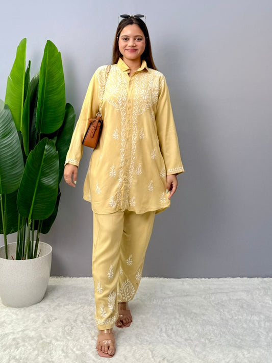 Woman in lemon yellow chikankari coord set with collared kurta and embroidered pants