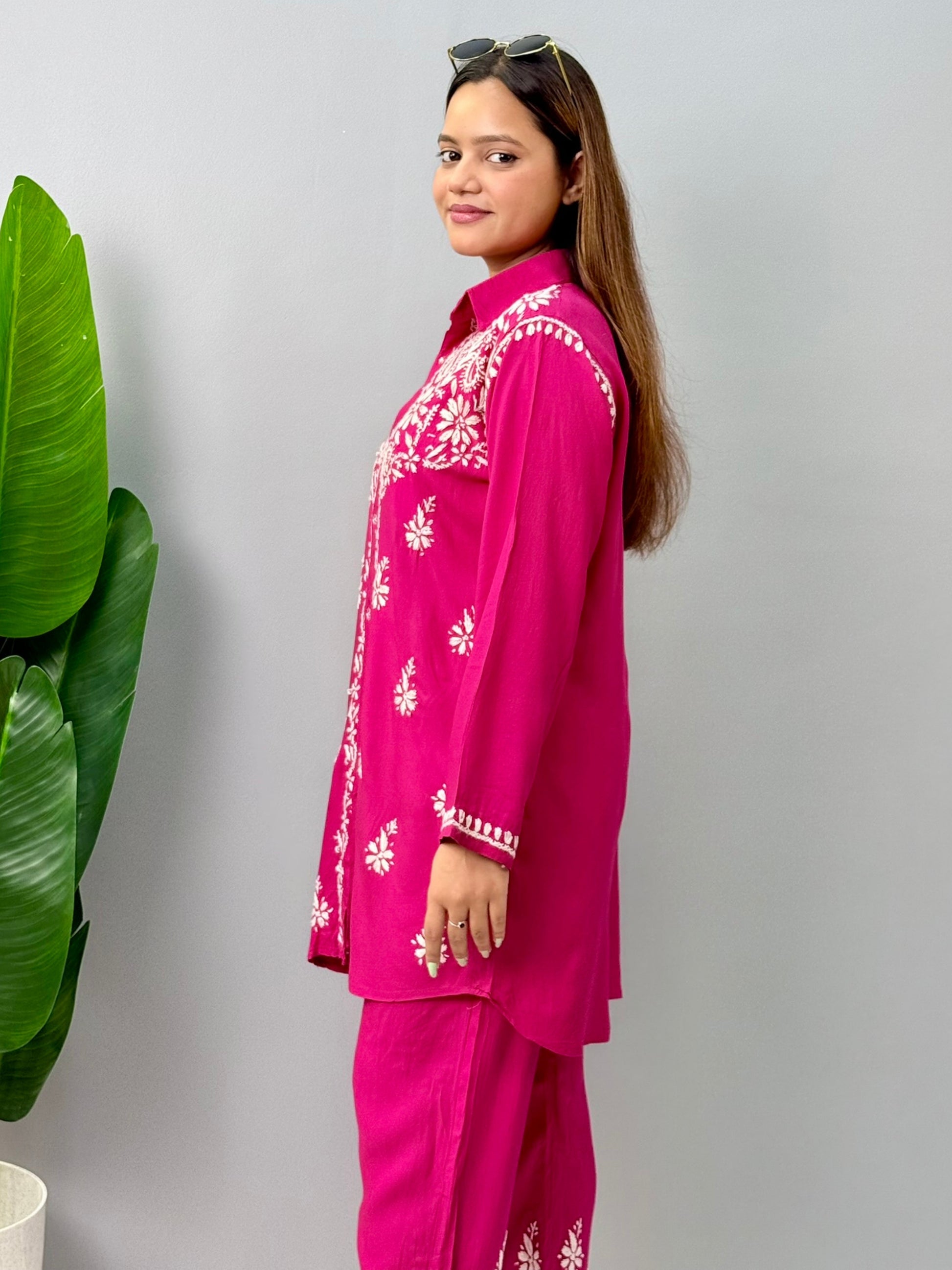 Woman wearing dark pink chikankari coord set with collared kurta and embroidered pants