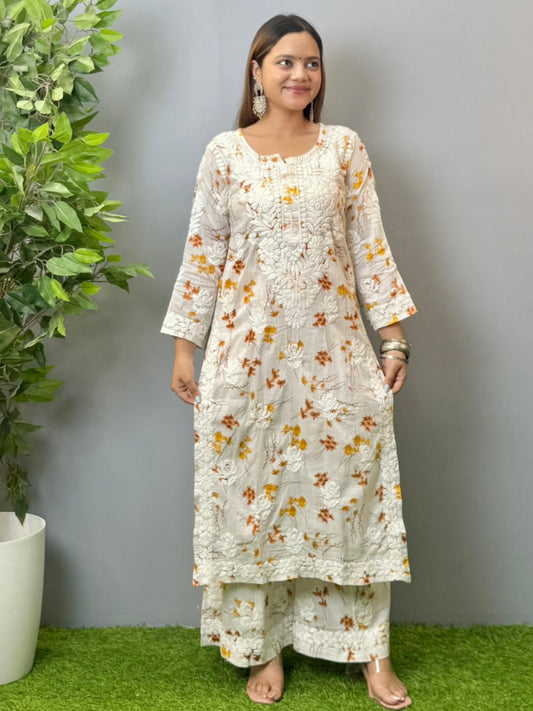 Model wearing ivory mulmul kurta and palazzo set with floral print and 3D hand embroidery.