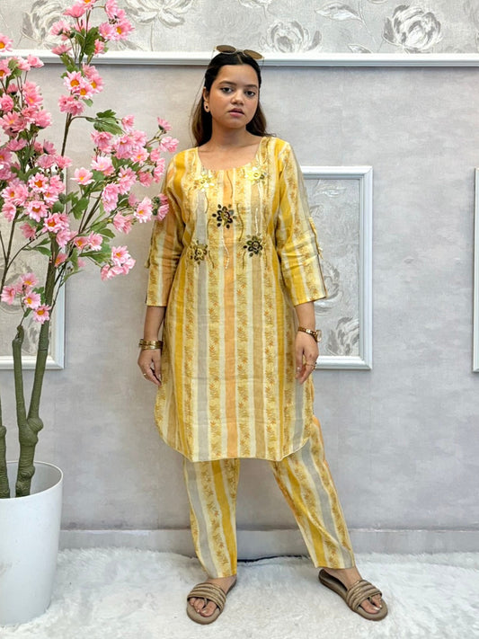 Yellow muslin printed co-ord set with floral embellishments and striped kurta and pants
