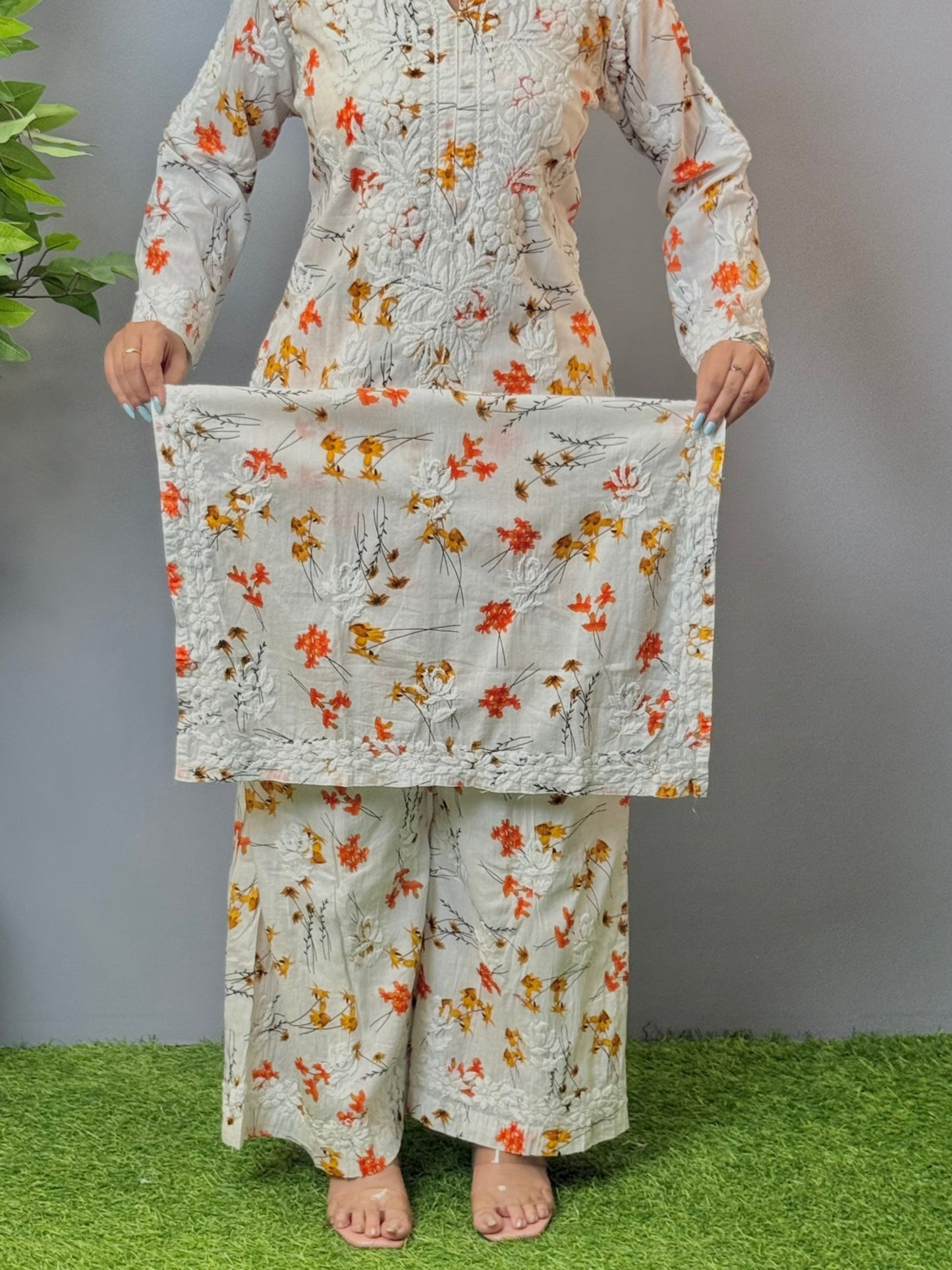Model wearing ivory floral printed mulmul chikankari kurta and palazzo set with detailed 3D embroidery.