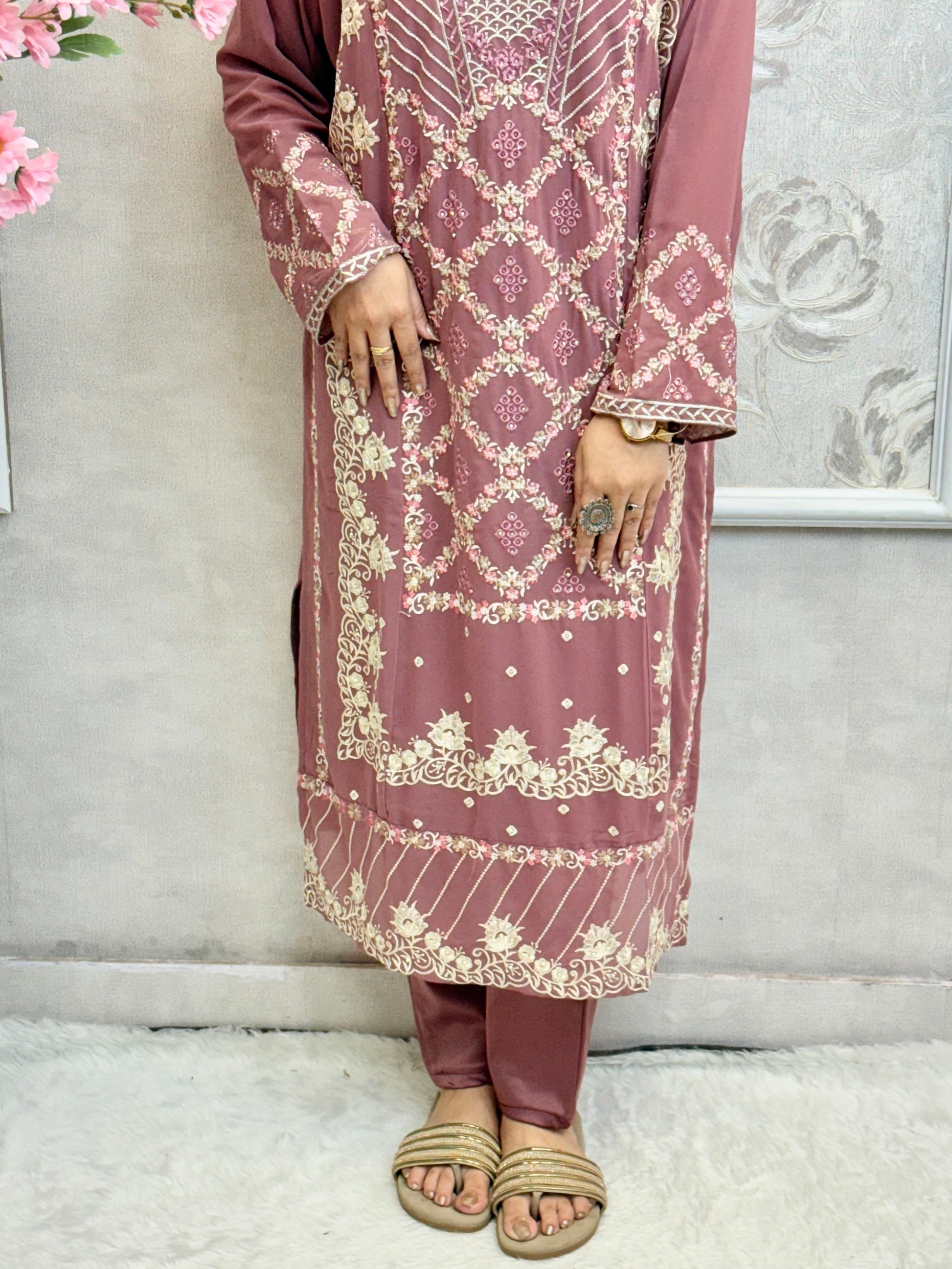 Model wearing a mauve georgette embroidered kurta with lycra stretchable pants and embroidered georgette dupatta – Designer Wear Collection.
