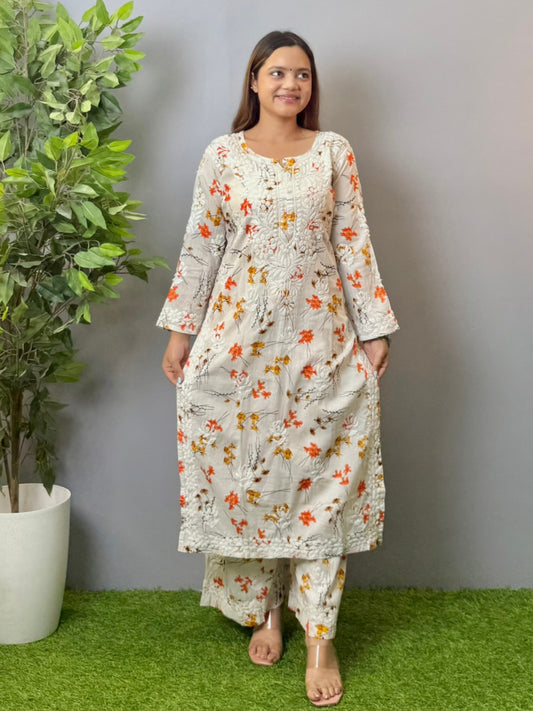 Model wearing ivory floral printed mulmul chikankari kurta and palazzo set with detailed 3D embroidery.