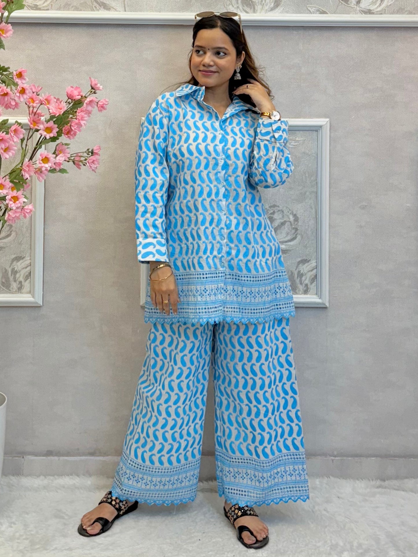 Model wearing a sky blue printed cotton co-ord set with fine machine work – kurta shirt and wide-leg palazzo pants – Designer Wear Collection.
