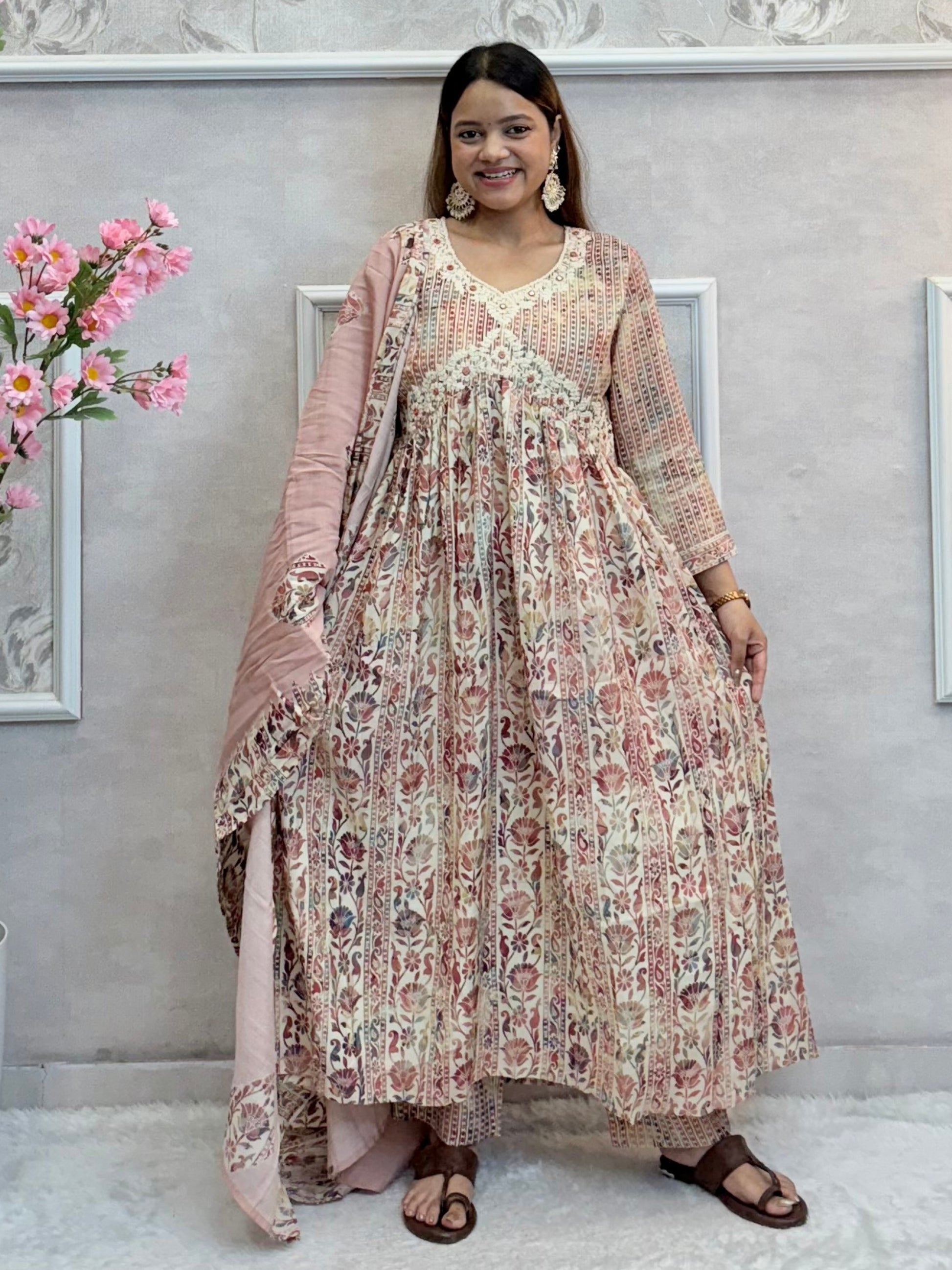 Model wearing a dusty rose floral long flared chanderi silk dress with hand embroidery – Designer Wear Collection.