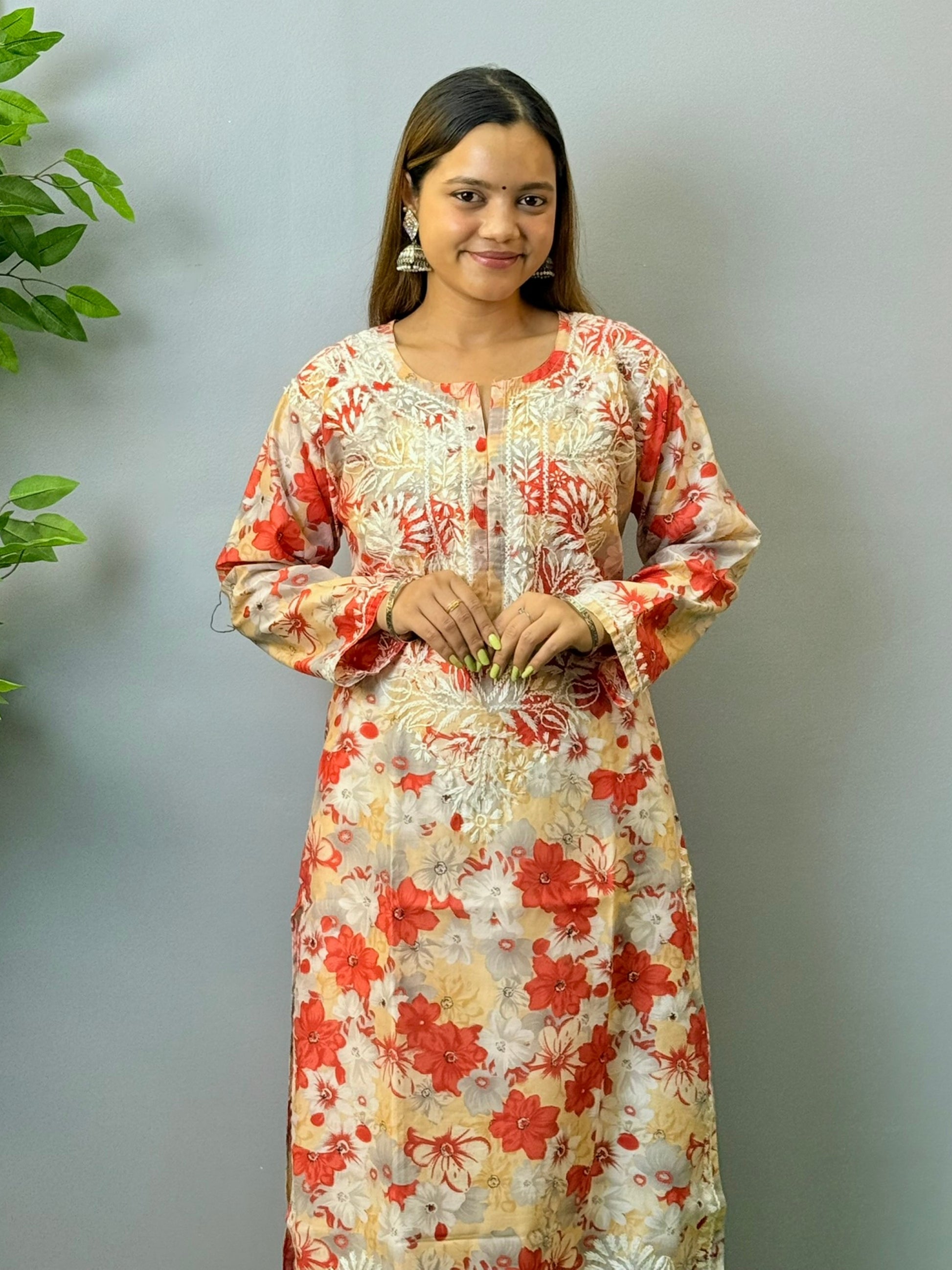 Model wearing beige and red floral chikankari kurta in crape fabric with white embroidery