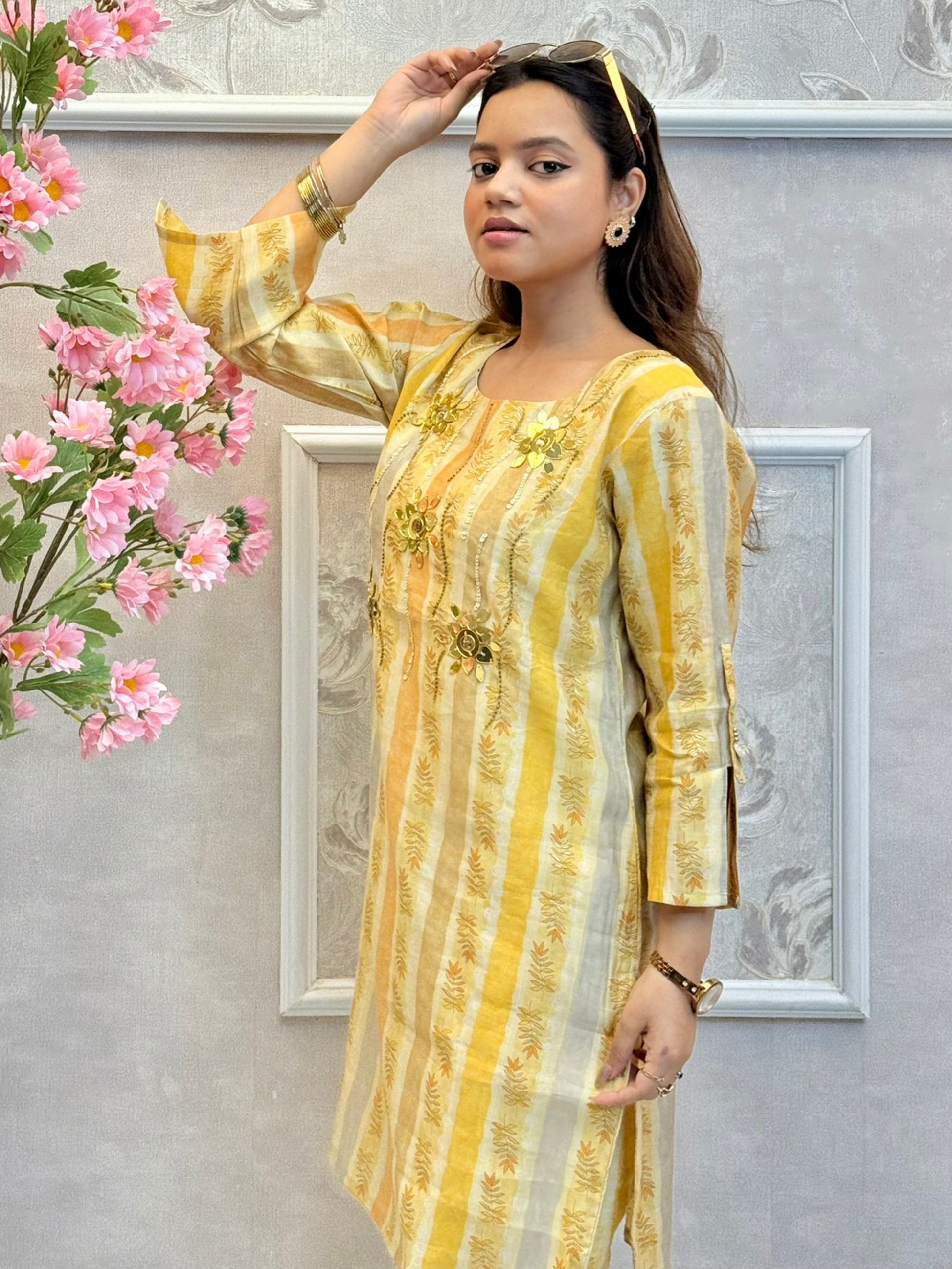 Yellow muslin printed co-ord set with floral embellishments and striped kurta and pants