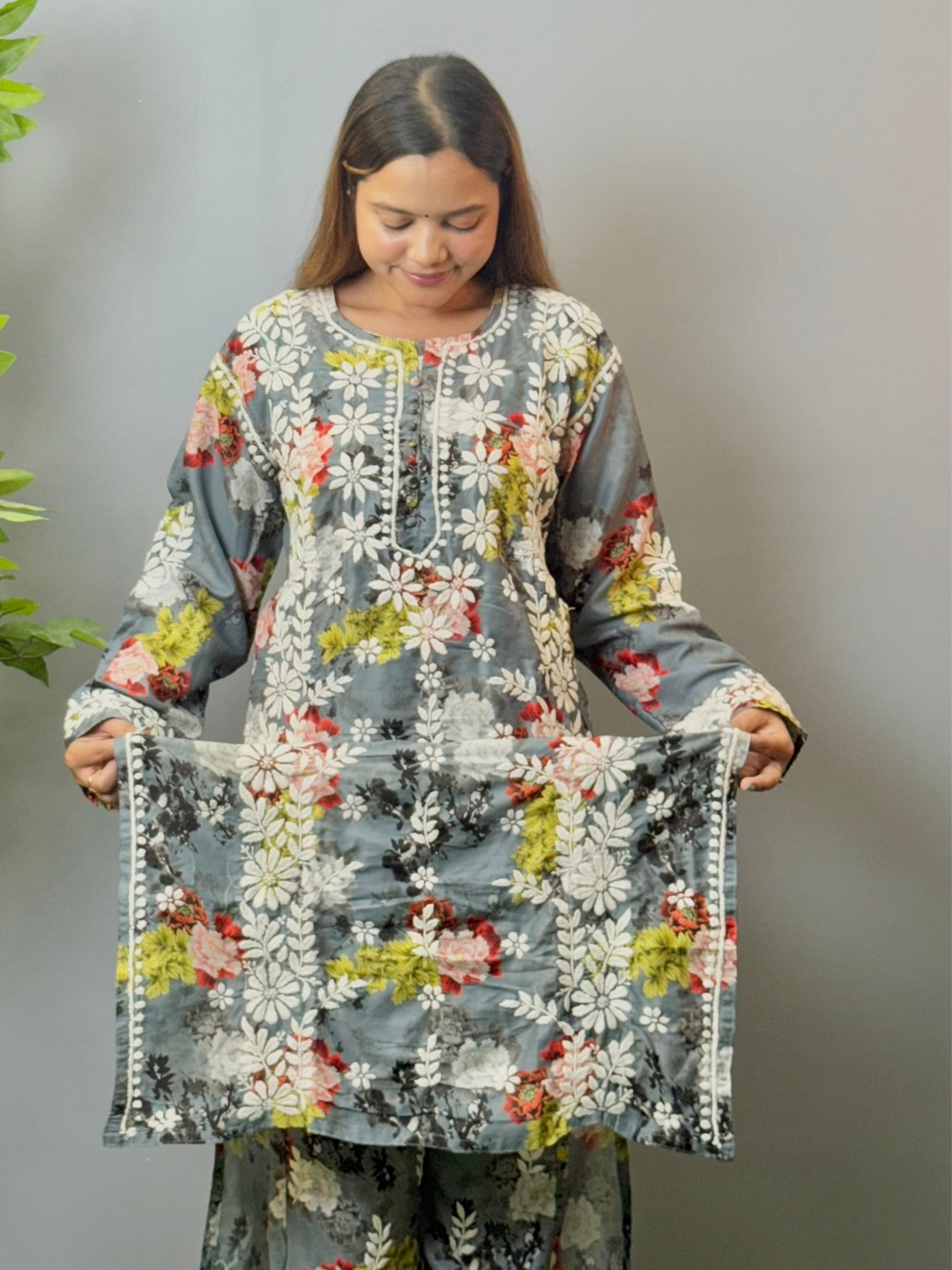 Model wearing charcoal floral muslin kurta and pant set with white Lucknowi chikankari and 3D hand embroidery.