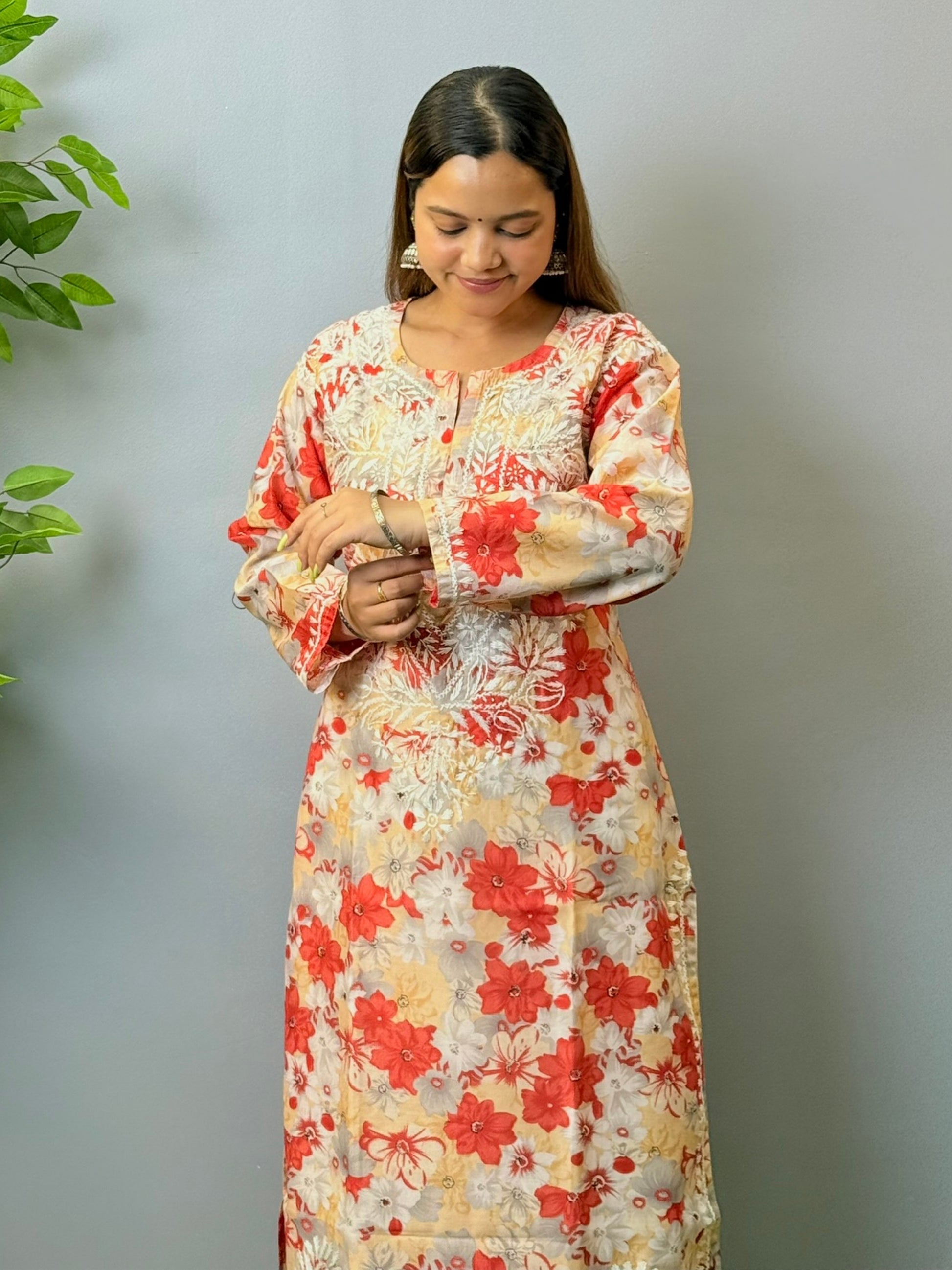 Model wearing beige and red floral chikankari kurta in crape fabric with white embroidery
