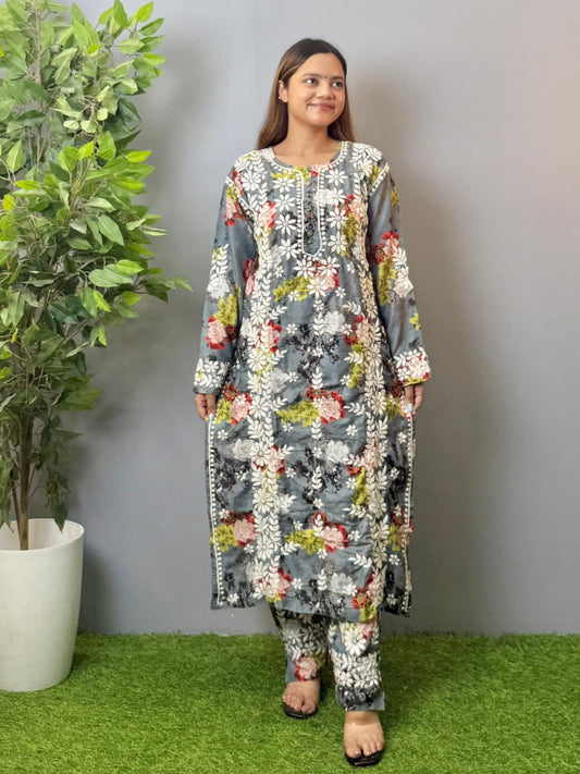 Model wearing charcoal floral muslin kurta and pant set with white Lucknowi chikankari and 3D hand embroidery.