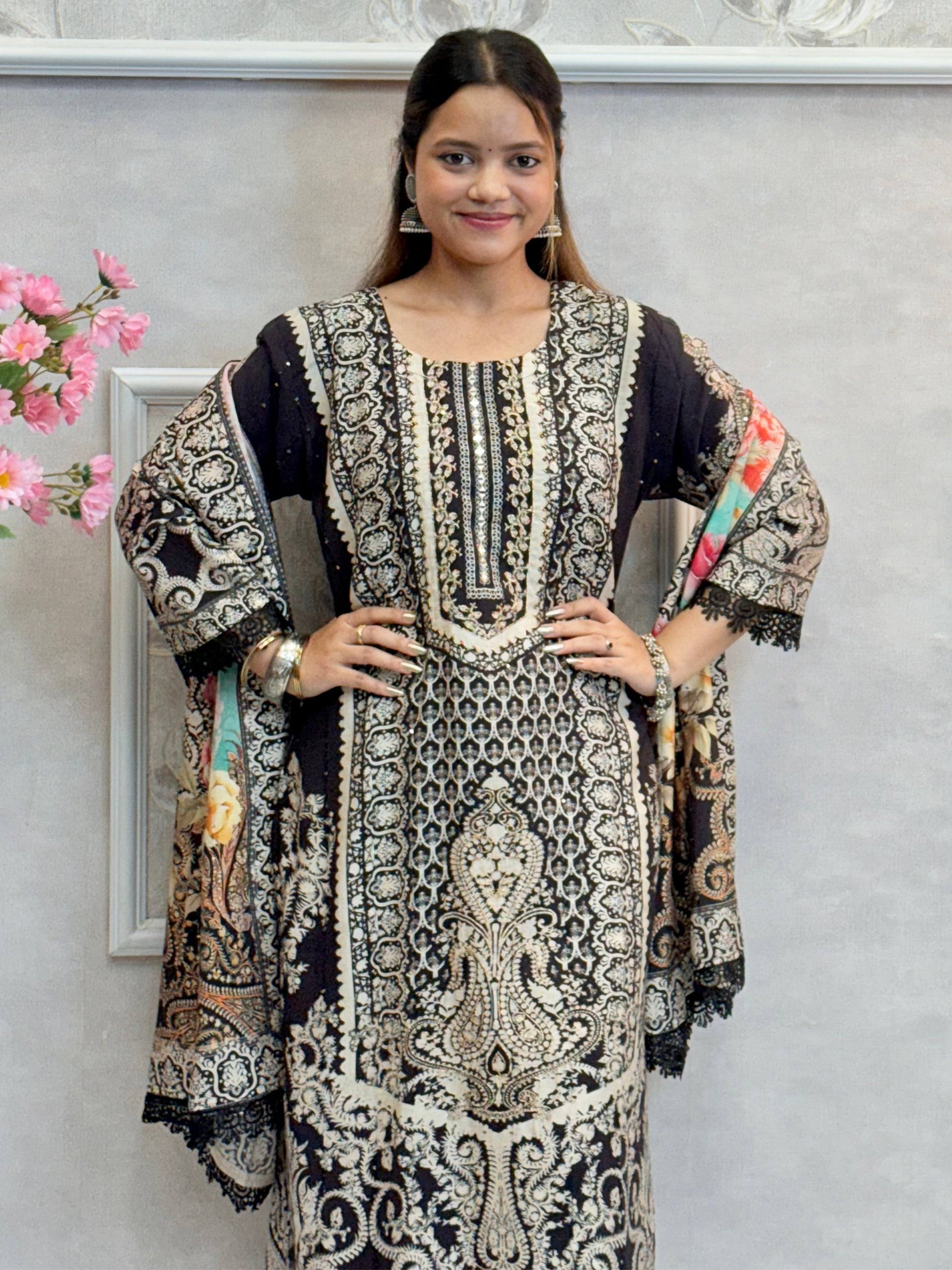 Model wearing a black printed mulmul kurta with mulmul pants and a multicolor printed mulmul dupatta – Designer Wear Collection.