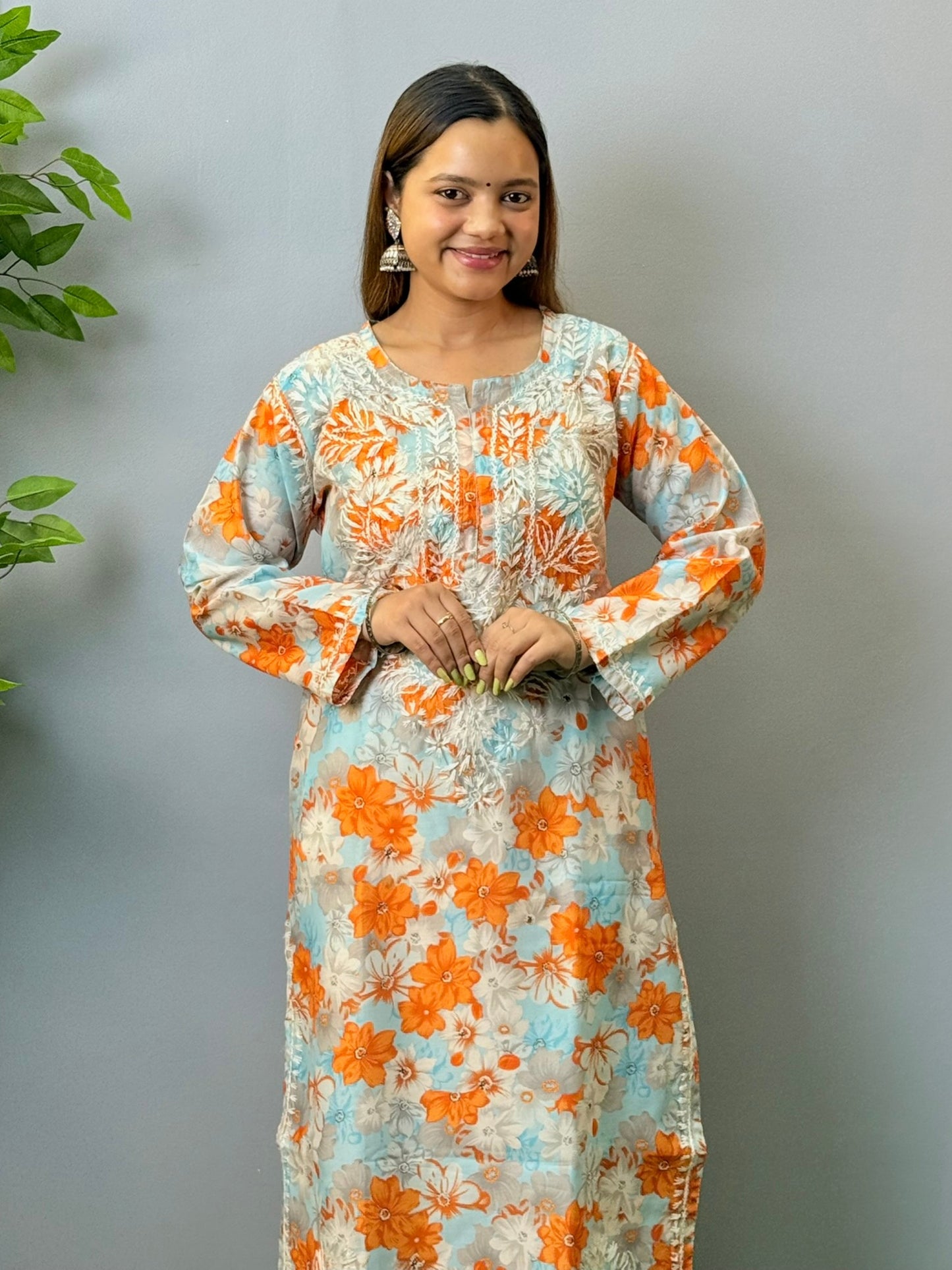 Model wearing sky blue and orange printed chikankari crape kurta with white embroidery