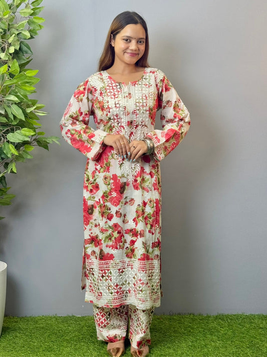 Model wearing floral white mulmul Lucknow chikankari kurta and pant set with pink rose print and white embroidery.