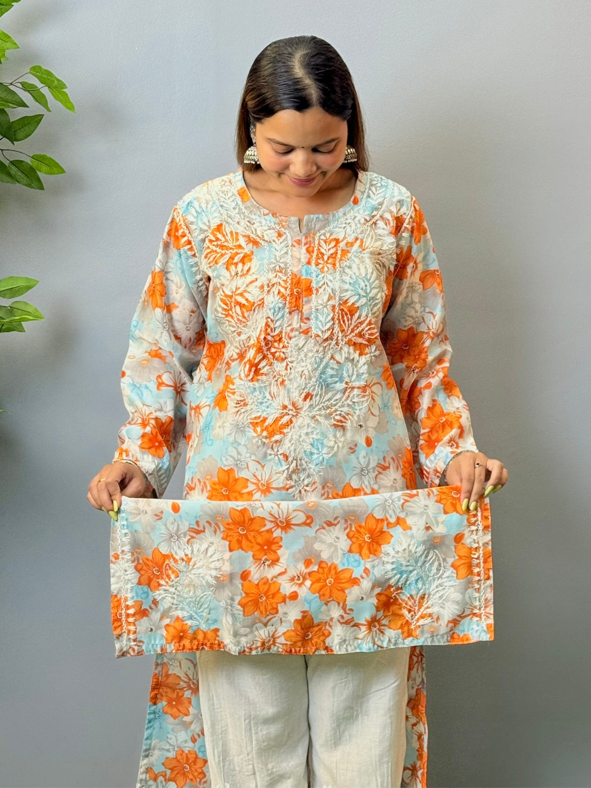 Model wearing sky blue and orange printed chikankari crape kurta with white embroidery