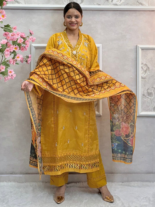 Model wearing a mustard yellow organza kurta with hand embroidery, paired with chanderi pants and a multicolor printed cotton dupatta – Designer Wear Collection.