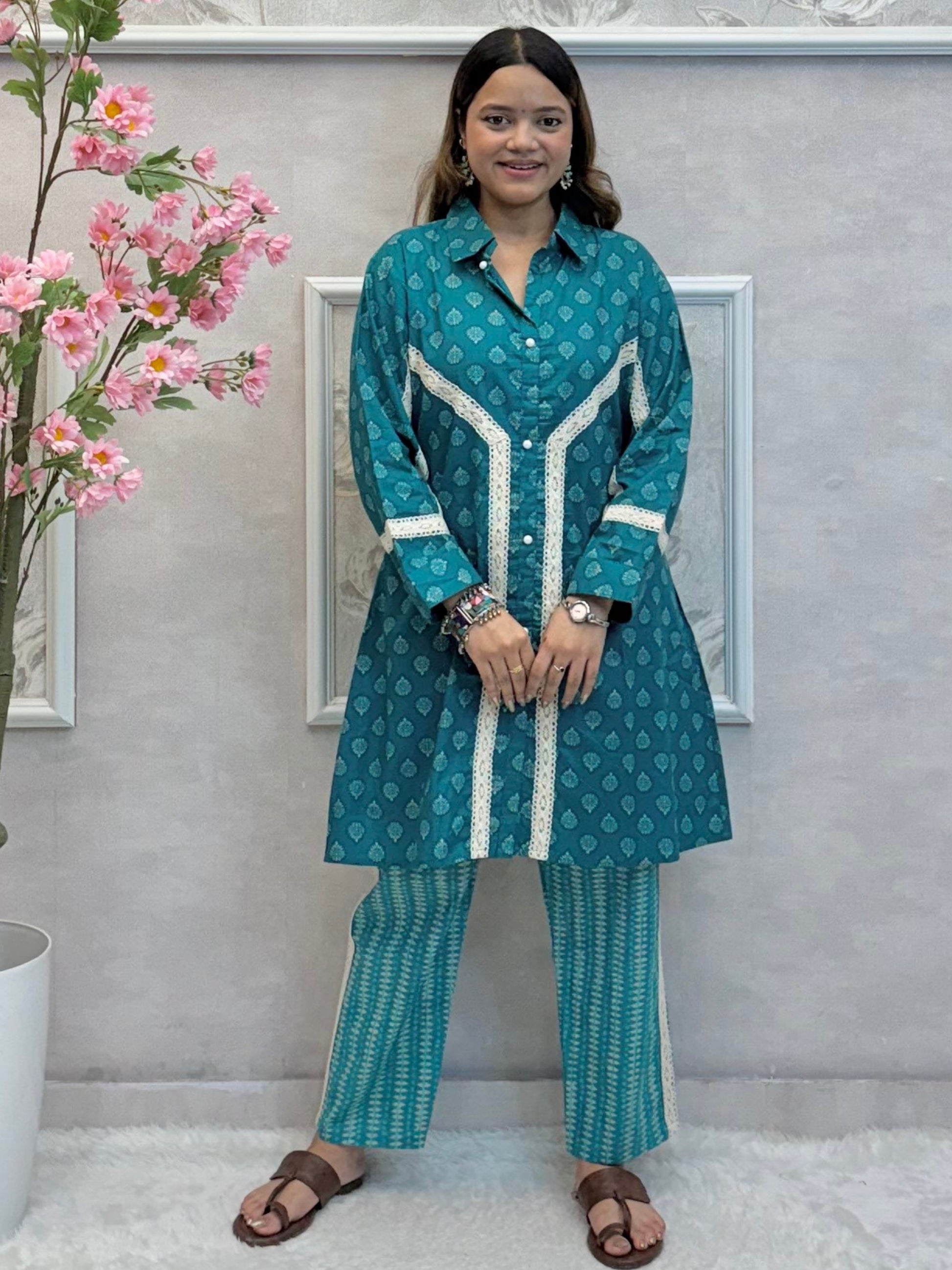 Model wearing a teal blue mulmul co-ord set with button-down kurta and printed straight pants – Designer Wear Collection.