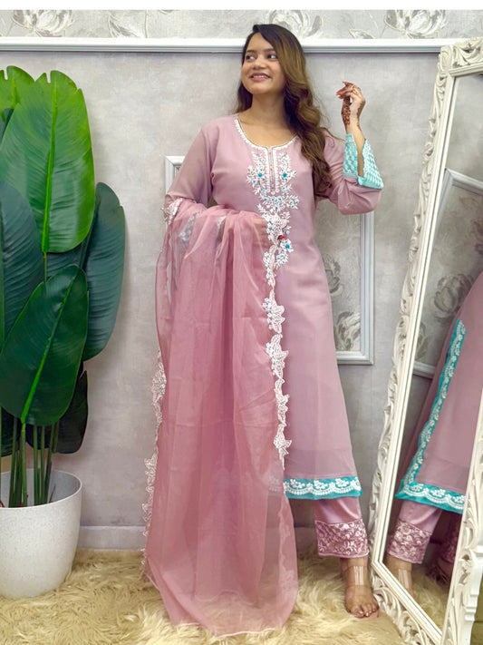 Model wearing a dusty pink georgette kurta with hand embroidery, lycra stretchable pants, and an organza dupatta – Designer Wear Collection.
