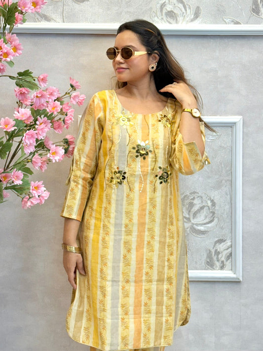 Yellow muslin printed co-ord set with floral embellishments and striped kurta and pants