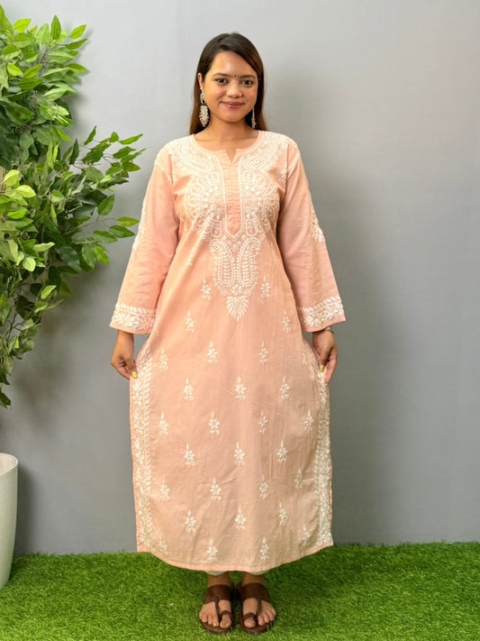 Model wearing a peach pink cotton chikankari kurta with delicate white hand embroidery