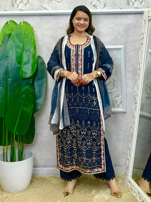 Model wearing a navy blue rayon kurta with intricate machine embroidery, paired with rayon pants and a chiffon dupatta – Designer Wear Collection.