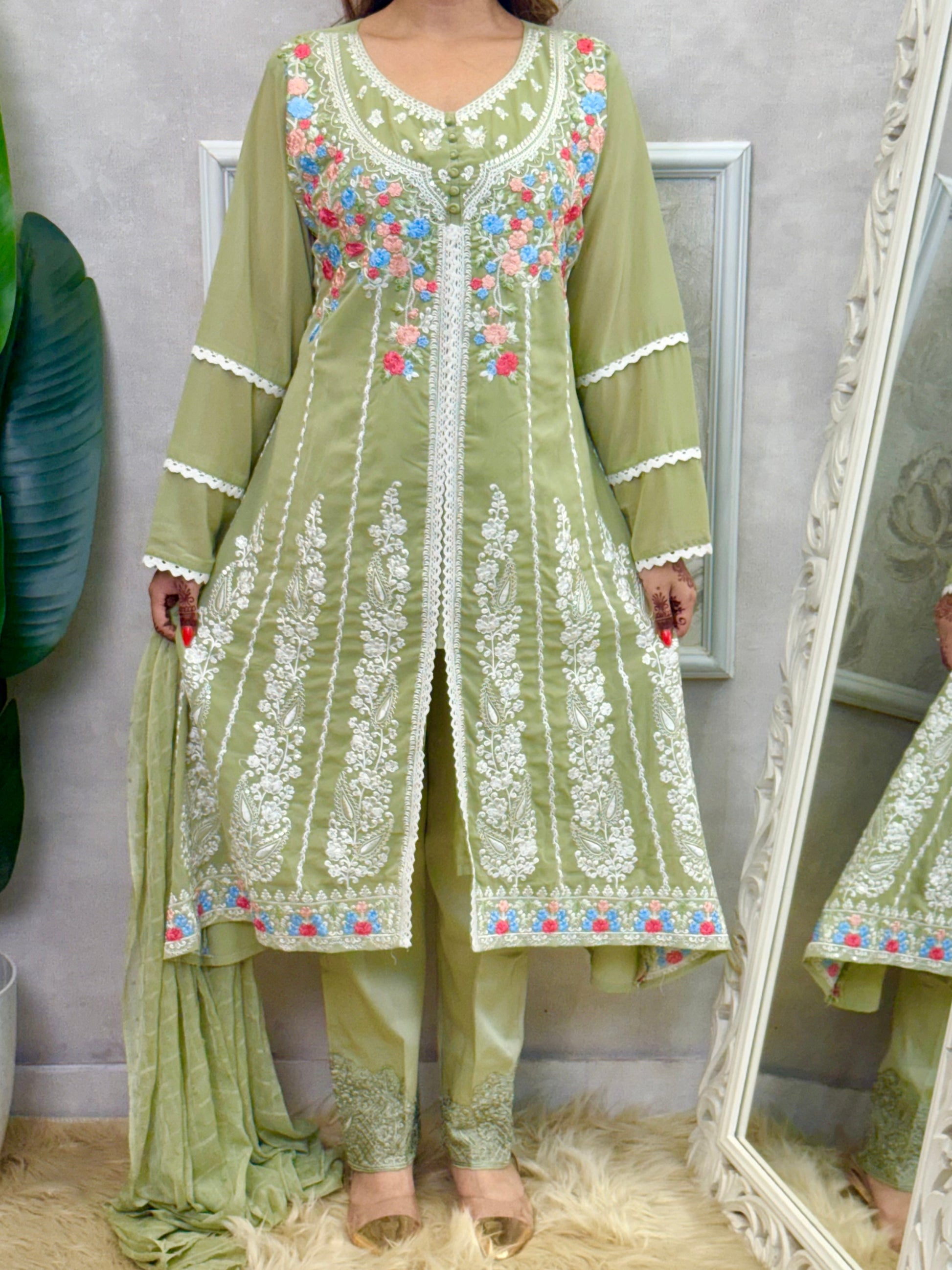 Model wearing a sage green embroidered georgette kurta with lycra stretchable pants and a chiffon dupatta – Designer Wear Collection.