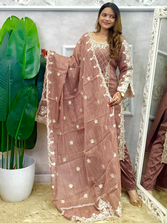 Model wearing a dusty brown soft organza kurta with hand embroidery, lycra stretchable pants, and a matching embroidered soft organza dupatta – Designer Wear Collection.