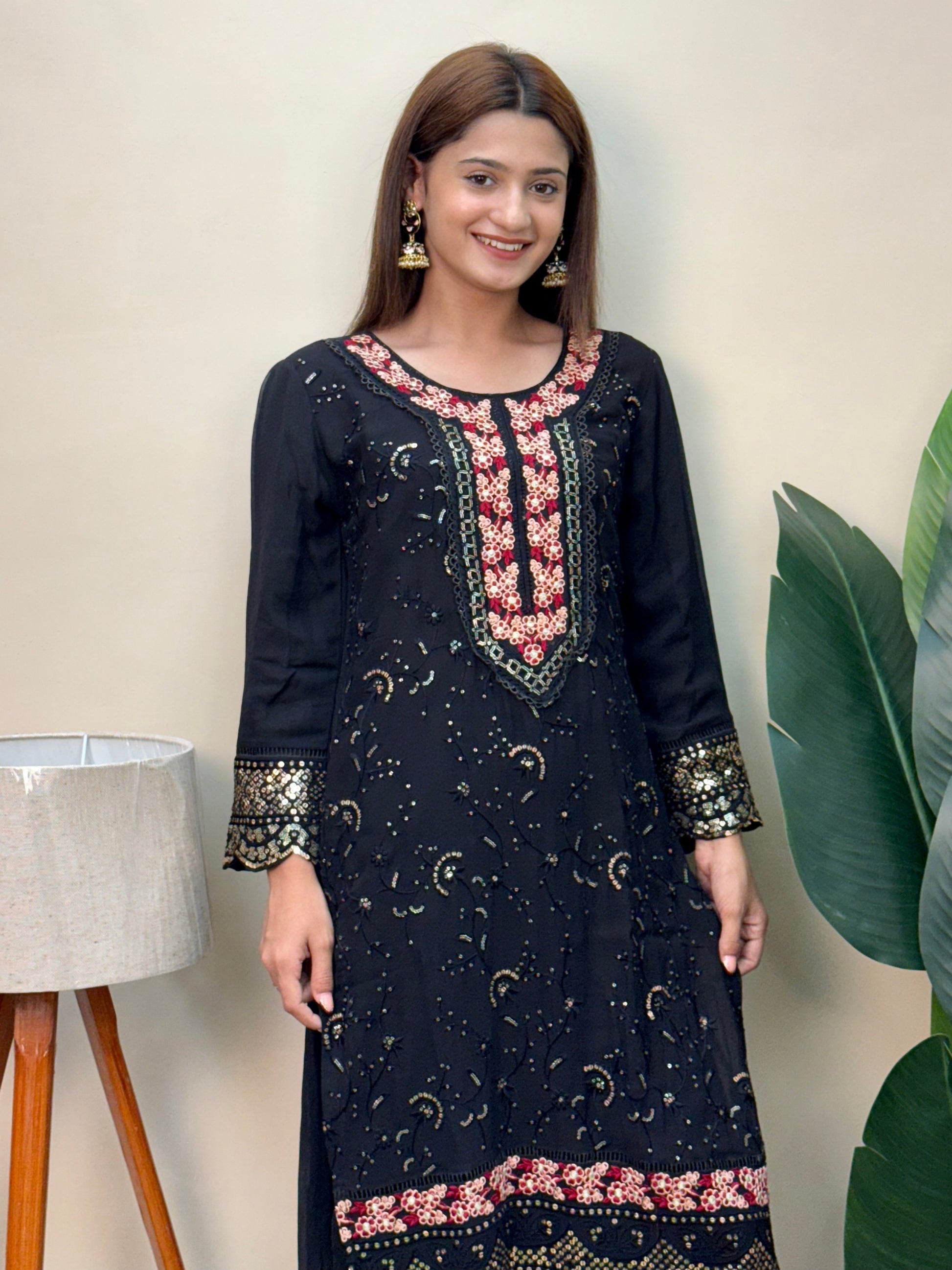 Model wearing a black rayon embroidered kurta with rayon pants and a printed chiffon dupatta – Designer Wear Collection.