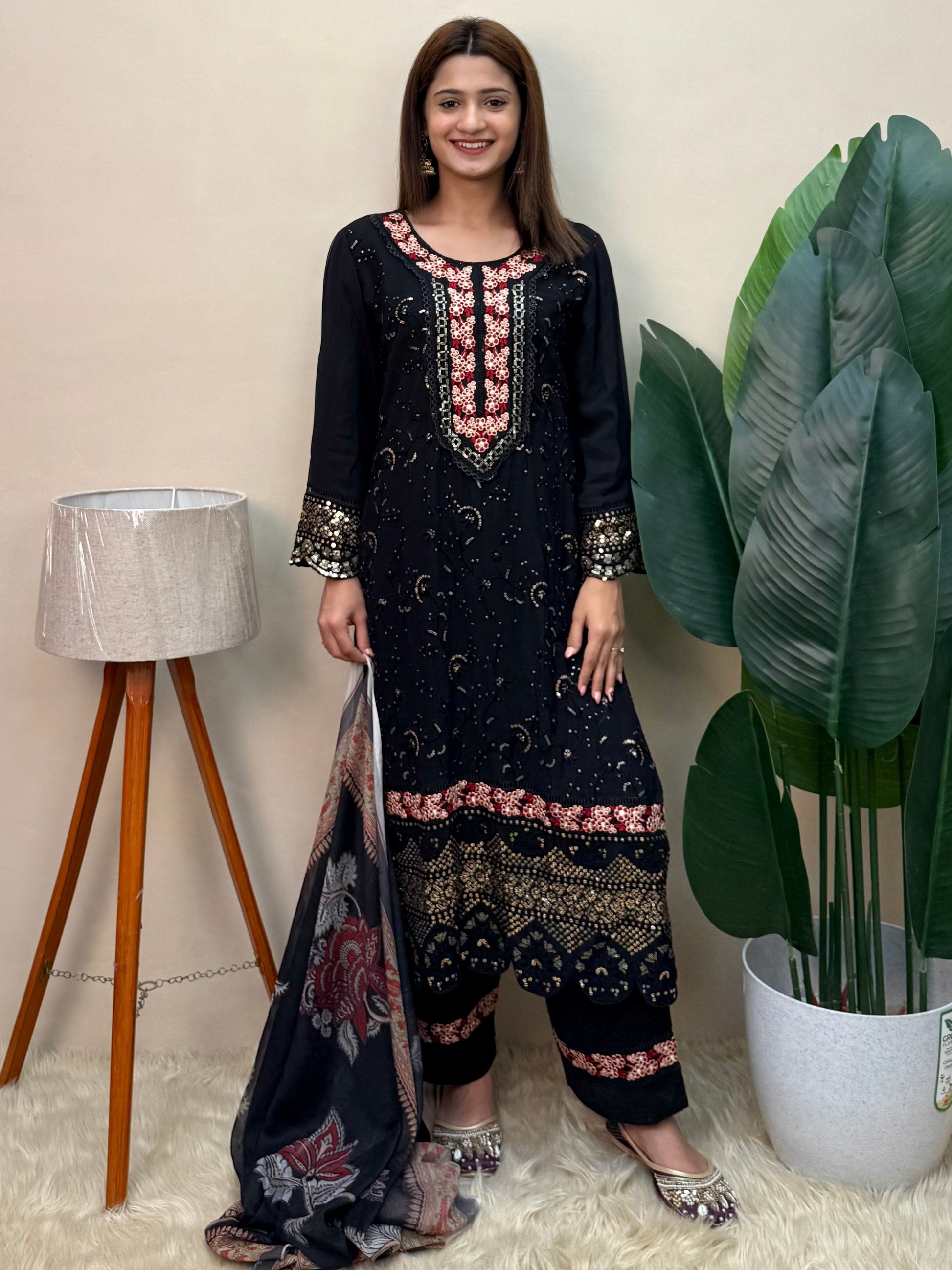 Model wearing a black rayon embroidered kurta with rayon pants and a printed chiffon dupatta – Designer Wear Collection.