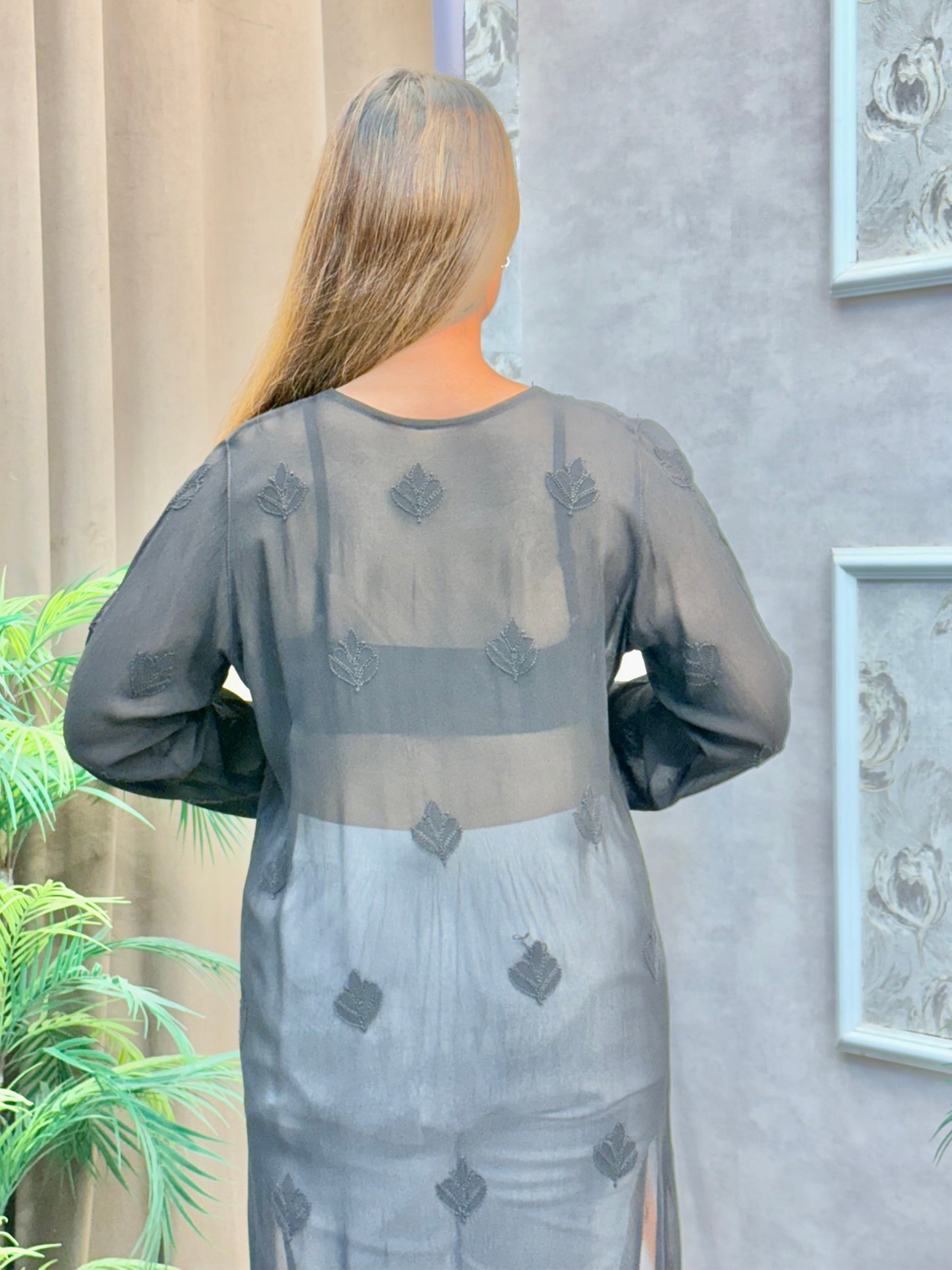 Woman wearing charcoal black chikankari kurta with tonal embroidery and V-neck design