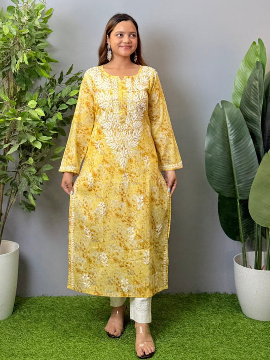 Model wearing a yellow printed mulmul chikankari kurta with white embroidery – perfect for summer